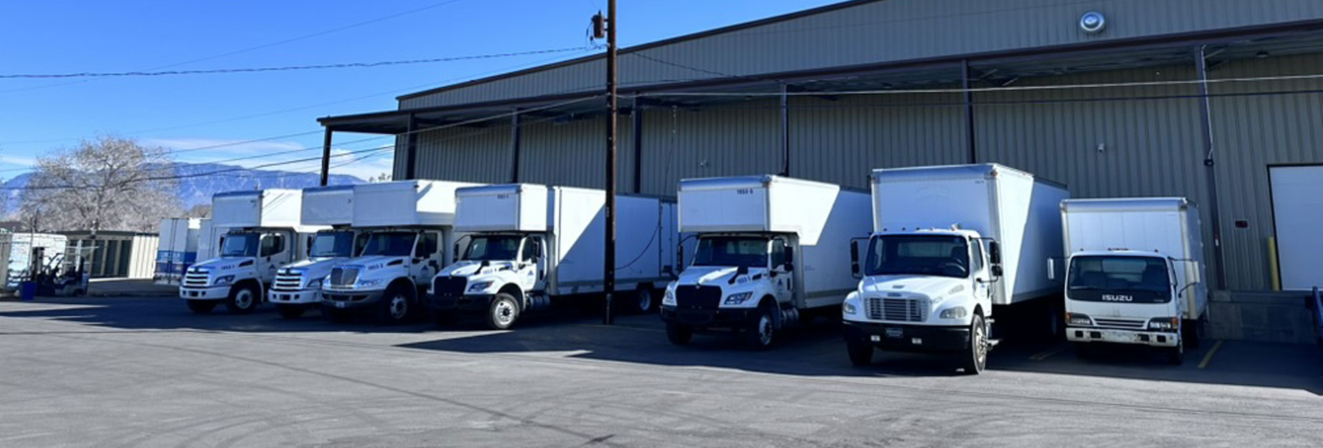 Apaca trucks lined up near warehouse