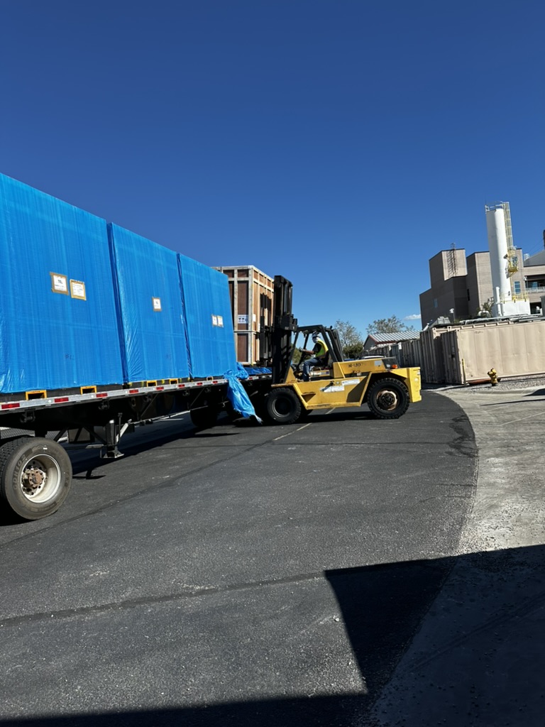 Unloading crates from APACA's moving truck