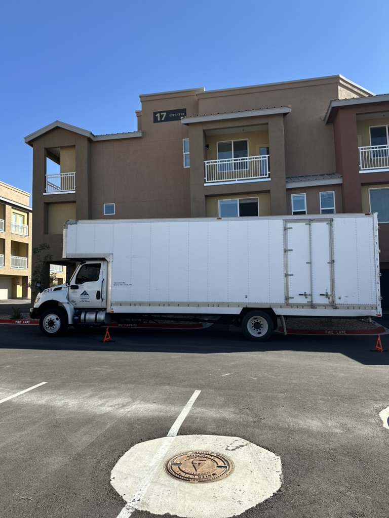 Moving truck in front of apartment building