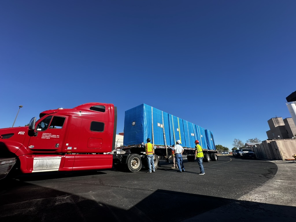 Unloading high tech manufacturing machinery from moving truck.