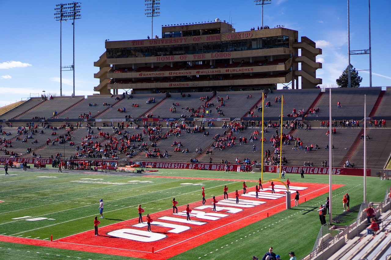 University of New Mexico field with cheerleaders in the end zone.